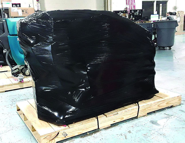 Floor scrubber wrapped and palletized for shipment